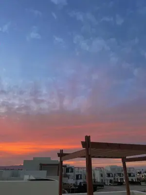 a wooden bench in front of a sunset at Gouna Getaway in Hurghada