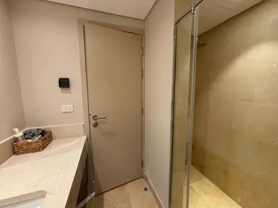 a bathroom with a shower and a glass door at El gouna mangrouovy in Hurghada