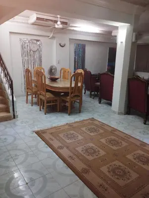 a living room with a wooden table and chairs at جبل تقوق فيلا عبدالله محروس in Aswan