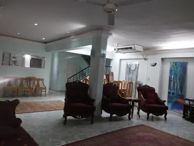 a living room with chairs and a table and a staircase at جبل تقوق فيلا عبدالله محروس in Aswan