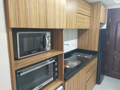 a small kitchen with a microwave and a television at Scandic resort hurghada in Hurghada