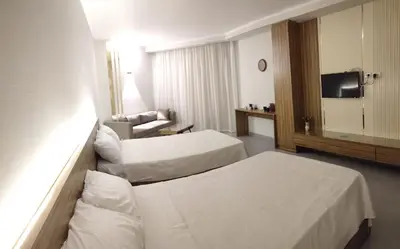 a hotel room with two beds and a television at Scandic resort hurghada in Hurghada