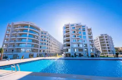 a swimming pool in front of two tall buildings at Scandic Resort Hurghada, Sea View in Hurghada