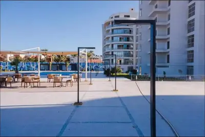 a street light with tables and chairs and a building at Scandic Resort Hurghada, Sea View in Hurghada