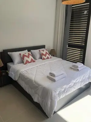 a large white bed with towels on top of it at Luxury stay in El Gouna