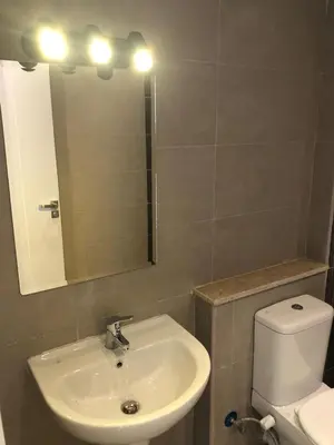 a bathroom with a sink and a toilet and a mirror at Luxury stay in El Gouna