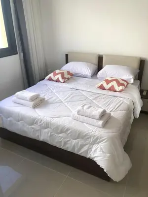 a large white bed with towels on top of it at Luxury stay in El Gouna