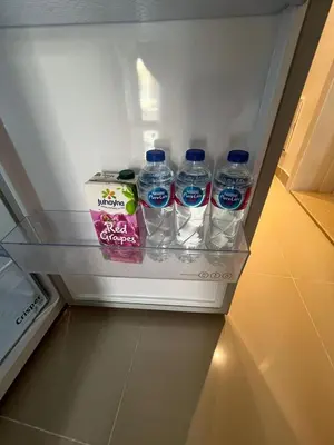 a refrigerator with bottles of water and a box in it at Studio el Gouna holiday G cribs Compound in Hurghada