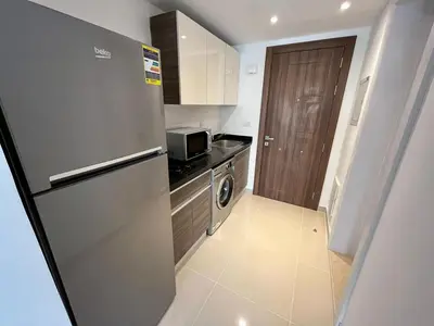 a small kitchen with a refrigerator and a microwave at Studio el Gouna holiday G cribs Compound in Hurghada
