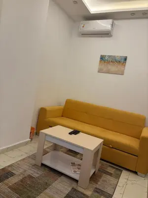 a living room with a couch and a coffee table at البلكان بيتش ريزورت Balkan Beach Resor in Hurghada