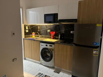 a kitchen with a washing machine and a microwave at البلكان بيتش ريزورت Balkan Beach Resor in Hurghada