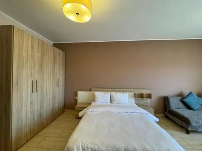 a bedroom with a large bed and a couch at Aldau Heights in Hurghada