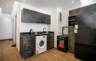 a kitchen with a washing machine and a washer at Al Saraya Sahl Hasheesh by Peak -One-Bedroom Apartment C316 in Hurghada