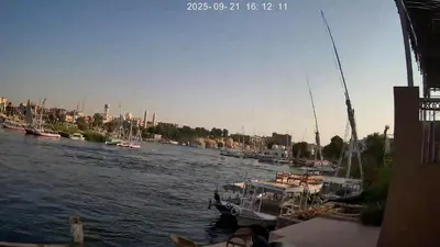 a group of boats are docked in a river at Nile Moon in Jazīrat Aswān