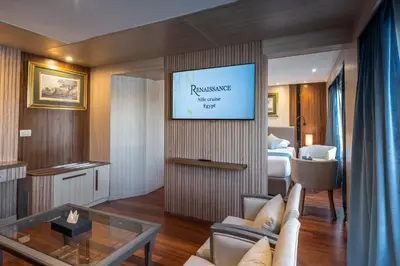 a living room with a tv on a wall at Renaissance Nile Cruise - Every Saturday from Luxor To Aswan for 4 Nights , and every Wednesday from Aswan To Luxor for 3 Nights in Luxor
