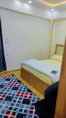 a bedroom with two beds and a rug at Hurghada in Hurghada