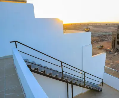 a view from the top of a building with a staircase at Peaceful Magawish Apartment in Hurghada