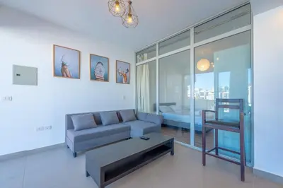 a living room with a couch and a chair at Modern 1BR with Pool View in Sholan El Gouna in Hurghada