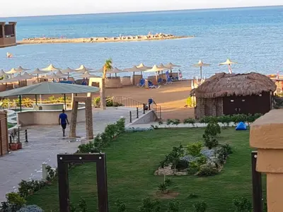 a view of a beach with umbrellas and the ocean at Impeccable 1-Bed Apartment in Hurghada in Hurghada