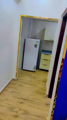 a kitchen with a white refrigerator in a room at Arrabia in Hurghada