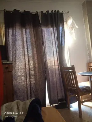 a window with curtains in a room with a chair at happy vacation in Hurghada