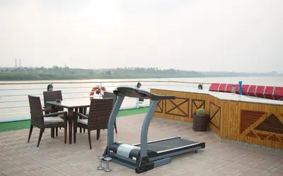 a deck of a boat with a table and a gym at King of The Vally Nile Cruise Aswan To Luxor 3 Night And visit the Nubian village in Aswan
