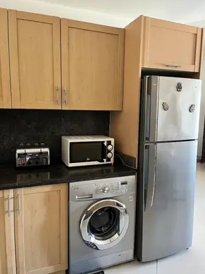 a kitchen with a stainless steel refrigerator and a microwave at A dream with a sea view in Azzurra in Hurghada