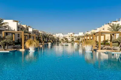 a swimming pool in the middle of a resort at Modish & Modern 1BDR Poolfront Mangroovy Free Pool & Beach in Hurghada