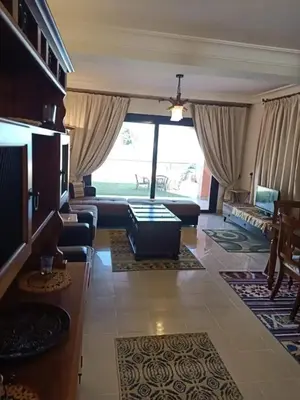 a living room with a couch and a table at Sea View Hurghada Holiday Home in Hurghada