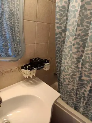 a bathroom with a toilet and a shower curtain at Sea View Hurghada Holiday Home in Hurghada