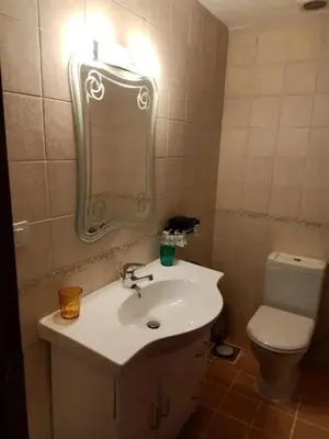 a bathroom with a sink and a toilet and a mirror at Sea View Hurghada Holiday Home in Hurghada