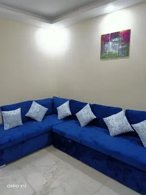 a blue couch in a living room with pillows on it at ميراج باى in Hurghada