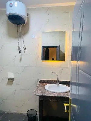 a bathroom with a sink and a mirror at Toutankhamon in Luxor