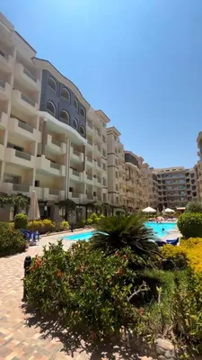 a large apartment building with a swimming pool at Florenza khamsin Resort in Hurghada