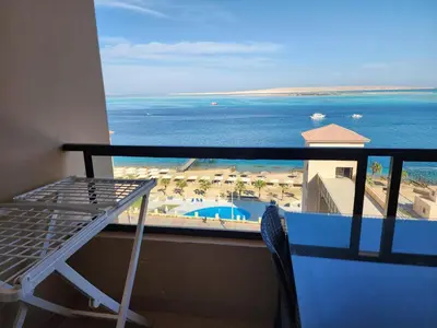 a balcony with a view of the beach and the ocean at Studio for rent in the view 607 in Hurghada
