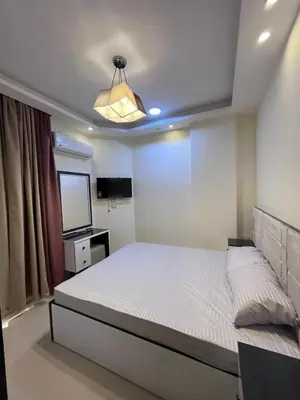 a bedroom with a white bed and a television at Casablanca Beach for families only in Hurghada