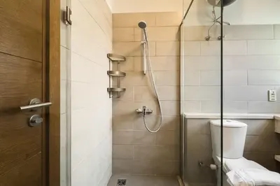 a bathroom with a shower with a toilet at The 2BDR Warmhearted Waterside Apt in Hurghada