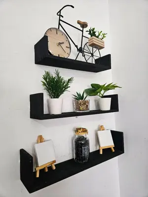 a shelf with two chairs and a clock on a wall at Sheraton Plaza 218 in Hurghada