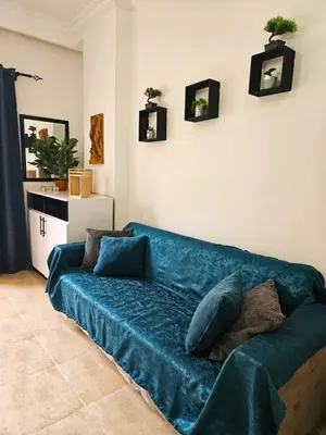 a blue couch in a living room with pillows on it at Sheraton Plaza 218 in Hurghada