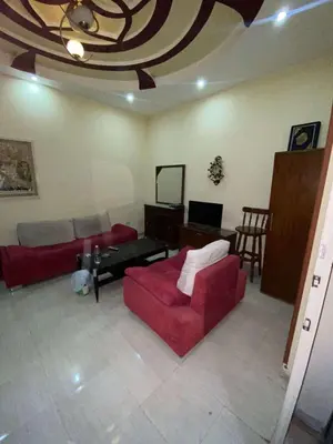 a living room with a red couch and a table at Villa with private pool A F in Hurghada