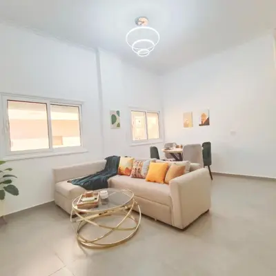 a living room with a couch and a table at Oasis Apartment in Safaga
