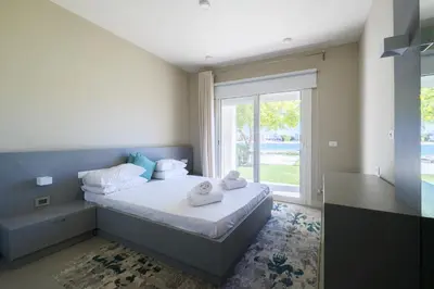 a bedroom with a bed and a large window at Joubal 2BR • Premium Ground Floor in Hurghada