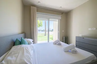 a bedroom with a large white bed with a window at Joubal 2BR • Premium Ground Floor in Hurghada