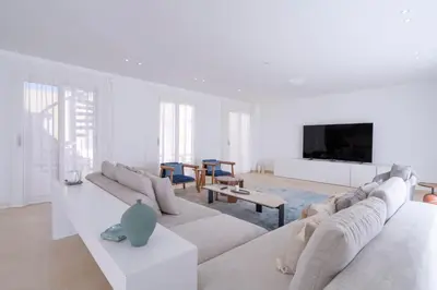 a white living room with a couch and a tv at Luxury 5BD Villa with Pool in Hurghada