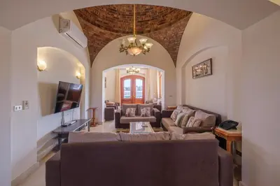 a living room with a couch and a tv at Serene 4BR Villa • Authentic West Golf in Hurghada