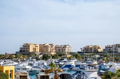 a bunch of boats parked in a harbor with buildings at 2BR New Marina Bliss • Cozy Centered Stay in Hurghada