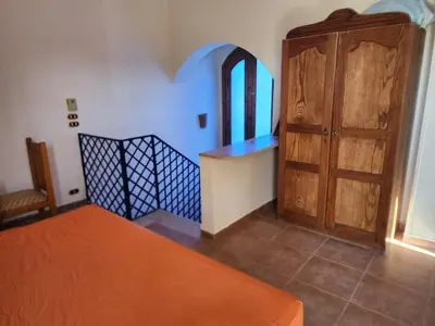 a room with a bed and a wooden door at 2BD Apt, Douplex, 2 floors, Villa Yanny, El Helal, Hurghada in Hurghada
