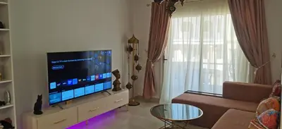 a living room with a large flat screen tv at Florenze Khamsin Hurghada in Hurghada