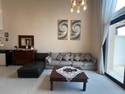 a living room with a couch and a table at Ancient Sands 4BR • Heated Pool Twin-Villa in Hurghada