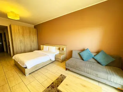 a bedroom with two beds and a couch at Sea View Aldau Hights in Hurghada